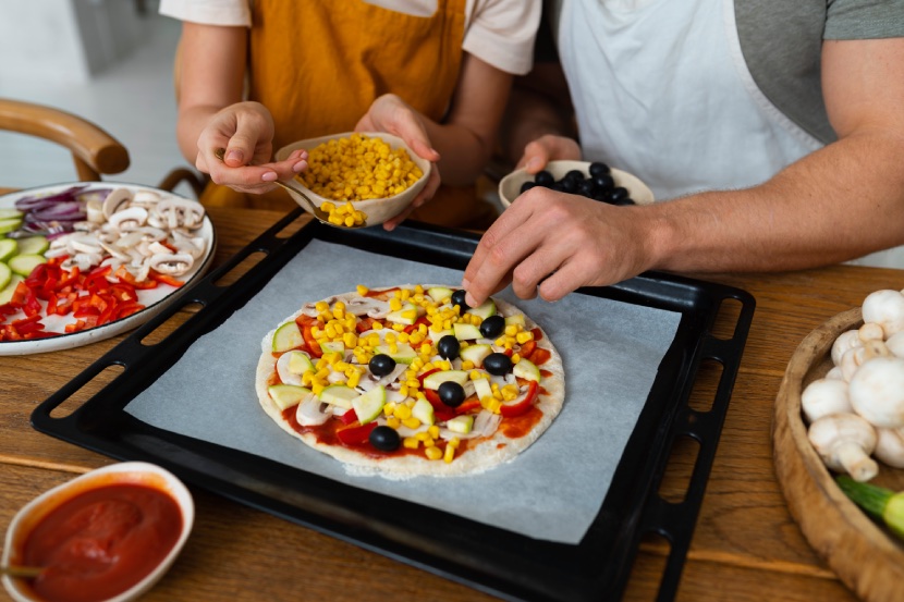 high angle people cooking pizza together 2