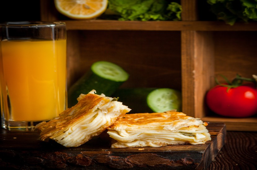 puff cheese cake with orange juice cucumbers tomato lettuce wooden plank 2